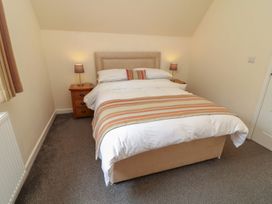 A bedroom with a double bed and bedside tables at James Ville Marina Lodge 13 in Brigg