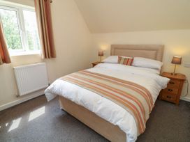 A bedroom with a bed and nightstands at James Ville Marina Lodge 13 in Brigg
