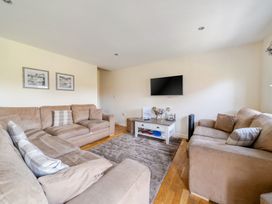 A living room with a television and two sofas at James Ville Marina Lodge 13 in Brigg
