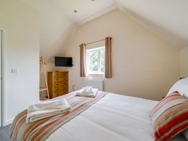 A bedroom with a bed and television at James Ville Marina Lodge 13 Brigg