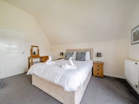 A bedroom with a bed and side table at James Ville Marina Lodge 13 in Brigg