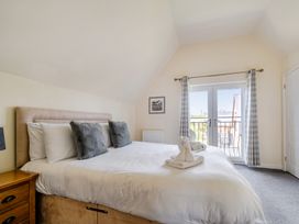 A bedroom with a bed and balcony door at James Ville Marina Lodge 13 in Brigg