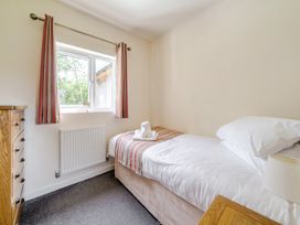 A bedroom with a bed and window at James Ville Marina Lodge 13 in Brigg