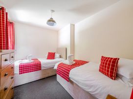 A bedroom with two beds and a chest of drawers at James Ville Marina Lodge 13 in Brigg