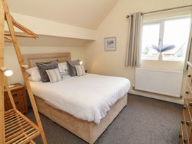 A bedroom with a double bed and bedside table at James Ville Marina Lodge 14 in Brigg
