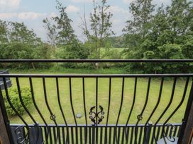 A view from a balcony overlooking grass and trees at James Ville Marina Lodge 14 in Brigg