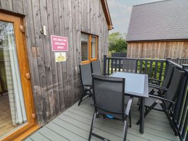 A decking area with a table and chairs at James Ville Marina Lodge 14 in Brigg