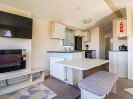 A kitchen with a table and cooker at Dunes View in Prestatyn