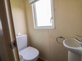 A bathroom with a toilet and sink at Dunes View in Prestatyn