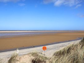A beach with sand and water at Dunes View in Prestatyn