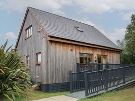 A wooden house with a deck and pathway at James Ville Marina Lodge 10 in Brigg