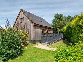 A house with a deck and garden at James Ville Marina Lodge 10 in Brigg