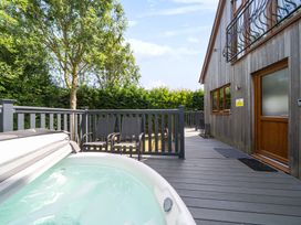 An outdoor area with a hot tub and chairs at James Ville Marina Lodge 10 in Brigg