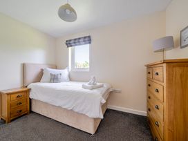A bedroom with a bed and nightstand at James Ville Marina Lodge 10 Brigg
