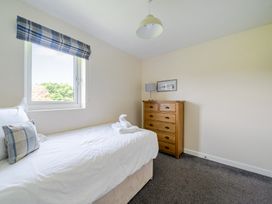 A bedroom with a bed and dresser at James Ville Marina Lodge 10 in Brigg