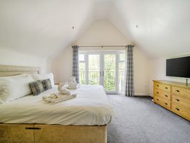 A bedroom with a bed and television at James Ville Marina Lodge 10 in Brigg