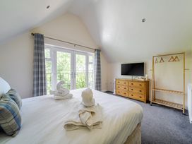 A bedroom with a bed and television at James Ville Marina Lodge 10 in Brigg