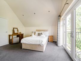 A bedroom with a bed and a mirror at James Ville Marina Lodge 10 in Brigg
