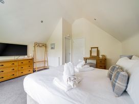 A bedroom with a bed and television at James Ville Marina Lodge 10 in Brigg