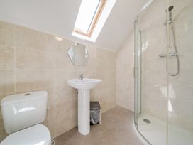 A bathroom with a shower, sink, and toilet at James Ville Marina Lodge 10 in Brigg