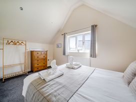 A bedroom with a bed and dresser at James Ville Marina Lodge 10 in Brigg