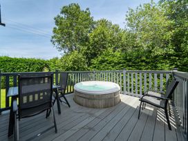 An outdoor area with a hot tub and seating at James Ville Marina Lodge 10 in Brigg