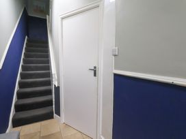 A hallway with stairs and a door at Apartment 1 Gr floor in Scarborough