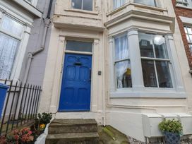 A blue door with number 8 and a window at Apartment 2 in Scarborough