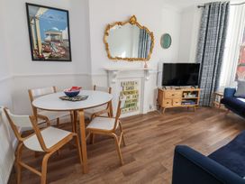 A living room with a television and a dining table at Apartment 2 in Scarborough