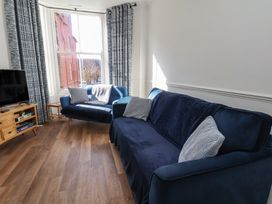 A living room with a sofa and television at Apartment 2 in Scarborough