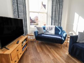 A living room with a sofa and television at Apartment 2 in Scarborough