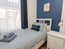 A bedroom with a bed and bedside table at Apartment 2 in Scarborough