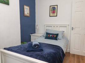 A bedroom with a bed and nightstand at Apartment 2 in Scarborough