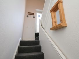 A staircase with a door and a welcome sign at Apartment 3 in Scarborough