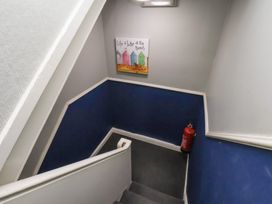 A staircase with wall artwork and a fire extinguisher at Apartment 3 in Scarborough