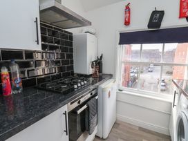 A kitchen with stove, fridge and window at Apartment 3 Scarborough