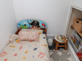 A bedroom with a bed and a small stool at Apartment 3 in Scarborough