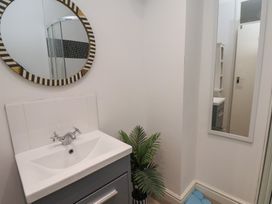 A bathroom with a sink and mirror at Apartment 3 in Scarborough