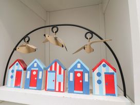 A decoration with five wooden beach houses and birds at Apartment 3 Scarborough