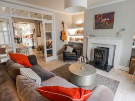 A living room with a sofa and fireplace at The Secret Garden in Narberth