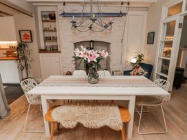 A dining room with a table and chairs at The Secret Garden in Narberth