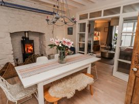 A dining room with a table and chairs at The Secret Garden in Narberth