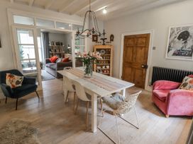A dining room with a table and chairs at The Secret Garden in Narberth