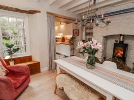 A dining room with a table and chairs at The Secret Garden in Narberth