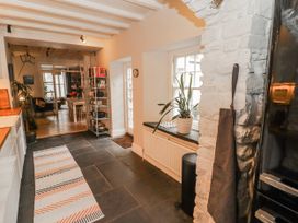 A kitchen with shelves and a plant at The Secret Garden in Narberth