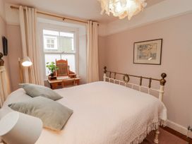 A bedroom with a bed and desk at The Secret Garden in Narberth