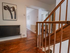 A hallway with a staircase and radiator at The Secret Garden in Narberth