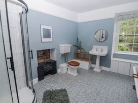 A bathroom with a shower, toilet and sink at The Secret Garden in Narberth