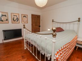 A bedroom with a bed and artwork on the wall at The Secret Garden in Narberth