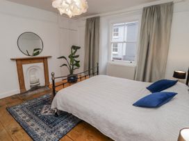 A bedroom with a bed and plant at The Secret Garden in Narberth